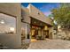 Large backyard patio with travertine flooring, dining area, and access to indoor living spaces at 10767 E Santa Fe Trl, Scottsdale, AZ 85262