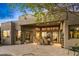 Expansive backyard patio with travertine flooring, dining area, and seamless indoor-outdoor living at 10767 E Santa Fe Trl, Scottsdale, AZ 85262