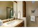 Bathroom vanity featuring a sink, wooden cabinetry, and wall mirror at 10767 E Santa Fe Trl, Scottsdale, AZ 85262