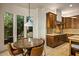 Charming breakfast nook adjacent to kitchen with bright natural light, custom cabinets, and seating for four at 10767 E Santa Fe Trl, Scottsdale, AZ 85262