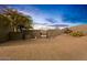 Desert home entry featuring a secure gate, native plants, privacy, and a picturesque Arizona sky at 10767 E Santa Fe Trl, Scottsdale, AZ 85262