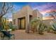 Southwestern-style home showcasing a landscaped entrance and desert plants at 10767 E Santa Fe Trl, Scottsdale, AZ 85262