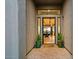 Inviting home entrance featuring a brick walkway, desert-themed plantings, and a clear view of the dining room at 10767 E Santa Fe Trl, Scottsdale, AZ 85262