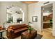 Cozy living room showcasing a decorative wall cut-out, comfortable seating, and adjacent access to kitchen and living spaces at 10767 E Santa Fe Trl, Scottsdale, AZ 85262