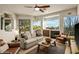 Bright living room with large windows offering beautiful views, a fireplace, and comfortable seating at 10767 E Santa Fe Trl, Scottsdale, AZ 85262