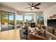 Inviting living room featuring a cozy fireplace, comfortable seating, and expansive windows with stunning views at 10767 E Santa Fe Trl, Scottsdale, AZ 85262