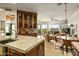 Open living space showcases the kitchen with granite counters and island seating, opening to an adjacent living space at 10767 E Santa Fe Trl, Scottsdale, AZ 85262