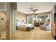 Relaxing main bedroom with a fireplace, seating area, and views of nature; plus walk-in shower at 10767 E Santa Fe Trl, Scottsdale, AZ 85262