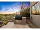 Outdoor grill area with a built-in BBQ, tile accents, and scenic desert landscaping at 10767 E Santa Fe Trl, Scottsdale, AZ 85262