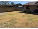 Backyard area with a grass lawn and brick wall at 11406 W Montana Ave, Youngtown, AZ 85363