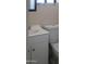 Clean half bathroom with white vanity, sink, and toilet with a tile floor at 11406 W Montana Ave, Youngtown, AZ 85363