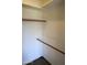 Empty walk-in closet featuring shelving and rod storage, and carpeted floors at 11406 W Montana Ave, Youngtown, AZ 85363