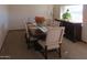 Elegant dining room featuring a large table, upholstered chairs, and natural light at 11406 W Montana Ave, Youngtown, AZ 85363