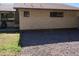 Exterior shot of the house showing brick siding, an outdoor bar and a gravel side yard at 11406 W Montana Ave, Youngtown, AZ 85363