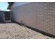 The side of the house has brick siding and a gated entrance at 11406 W Montana Ave, Youngtown, AZ 85363