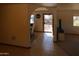 Hallway view showing front door and view into dining room and living room, with tile flooring at 11406 W Montana Ave, Youngtown, AZ 85363