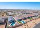 Community aerial view features homes with pools and artificial turf, showcasing neighborhood layout and design at 12686 E Pivot Peak --, Gold Canyon, AZ 85118