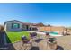 Relaxing backyard space with a pool, waterfall, artificial turf, rock landscaping, and cozy outdoor seating area at 12686 E Pivot Peak --, Gold Canyon, AZ 85118