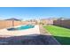 Stunning backyard view showcases a pool, waterfall, artificial turf, and rock landscaping, set against mountain views at 12686 E Pivot Peak --, Gold Canyon, AZ 85118