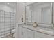 Stylish bathroom featuring a double vanity with a large framed mirror and tiled shower at 12686 E Pivot Peak --, Gold Canyon, AZ 85118