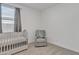 Neutral bedroom with crib, cozy chair, and window, creating a calming space at 12686 E Pivot Peak --, Gold Canyon, AZ 85118