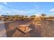 Active recreation area featuring cornhole, picnic tables, and green space for community engagement and outdoor enjoyment at 12686 E Pivot Peak --, Gold Canyon, AZ 85118