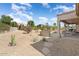 Expansive backyard with desert landscaping, gravel ground cover, and covered patio for outdoor enjoyment at 15542 W Cypress Point Dr, Surprise, AZ 85374