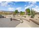 Desert landscaped backyard with mature cacti, decorative rock, and a concrete patio at 15542 W Cypress Point Dr, Surprise, AZ 85374