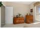 Bedroom featuring mid-century modern dressers with a white door leading to the rest of the house at 15542 W Cypress Point Dr, Surprise, AZ 85374