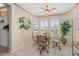 Bright breakfast nook with large windows and a ceiling fan at 15542 W Cypress Point Dr, Surprise, AZ 85374