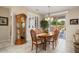 Elegant dining area with a wood table, decorative chandelier, and natural light at 15542 W Cypress Point Dr, Surprise, AZ 85374