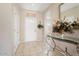 Inviting entryway with decorative console table, neutral walls, and tile flooring at 15542 W Cypress Point Dr, Surprise, AZ 85374