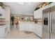 Bright kitchen featuring white cabinetry, tile floors, and stainless appliances at 15542 W Cypress Point Dr, Surprise, AZ 85374