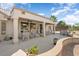 Covered patio with plenty of seating for entertaining, overlooking the low-maintenance desert landscape at 15542 W Cypress Point Dr, Surprise, AZ 85374