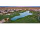 Panoramic aerial view of the community showcasing lush golf course, pristine lake, and well-maintained homes at 1805 E Atole Pl, Queen Creek, AZ 85140