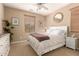 Charming bedroom with natural light, carpet flooring, and a classic white bed frame at 1805 E Atole Pl, Queen Creek, AZ 85140