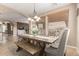 Dining area featuring a wooden table, bench seating, and natural light at 1805 E Atole Pl, Queen Creek, AZ 85140