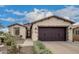 Charming single-story home featuring a two-car garage and desert landscaping at 1805 E Atole Pl, Queen Creek, AZ 85140