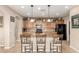 Well-lit kitchen with a breakfast bar, pendant lighting, and ample cabinet space at 1805 E Atole Pl, Queen Creek, AZ 85140