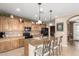 Kitchen with a central island, black appliances, and tile backsplash at 1805 E Atole Pl, Queen Creek, AZ 85140