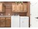 Well-organized laundry room features front load washer, dryer, and functional upper and lower cabinets at 1805 E Atole Pl, Queen Creek, AZ 85140