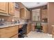 Functional home office area with built-in desk, cabinets, and tiled floor at 1805 E Atole Pl, Queen Creek, AZ 85140