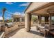 Covered outdoor patio with dining area and built-in grill, ideal for relaxing and dining at 1805 E Atole Pl, Queen Creek, AZ 85140