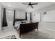 Well-lit bedroom features a ceiling fan, two windows, and neutral walls perfect for relaxation at 18400 E Donato Dr, Gold Canyon, AZ 85118