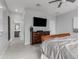 Bedroom with a ceiling fan, dresser, and television providing a cozy and functional living space at 18400 E Donato Dr, Gold Canyon, AZ 85118