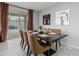 Elegant dining area with modern table, stylish chairs, and sliding glass door to the patio at 18400 E Donato Dr, Gold Canyon, AZ 85118