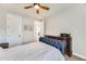 Bedroom with blue tufted headboard, white linens, and an ornate wood dresser at 1950 E Lantana Dr, Chandler, AZ 85286