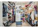 Organized walk-in closet with shelves, hanging rods, and a central stool at 1950 E Lantana Dr, Chandler, AZ 85286