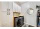 Well-organized laundry area with white cabinets, wooden countertop, modern washer/dryer, and stylish decor at 1950 E Lantana Dr, Chandler, AZ 85286