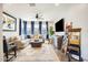 Cozy living room with large sectional couch, area rug, mounted TV, and lots of natural light at 1950 E Lantana Dr, Chandler, AZ 85286